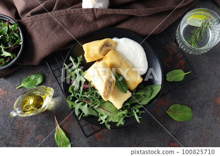 Concept of tasty food, thin pancakes with filling, top view Concept of tasty food, thin pancakes with filling, top view 100825710