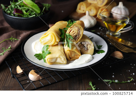 Concept of tasty food, thin pancakes with filling Concept of tasty food, thin pancakes with filling 100825714