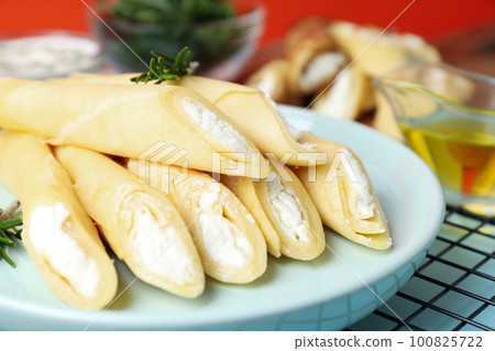 Concept of tasty food, thin pancakes with filling 100825722