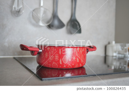 cooking pan on electric stove, electric stove is heated to red.  100826435