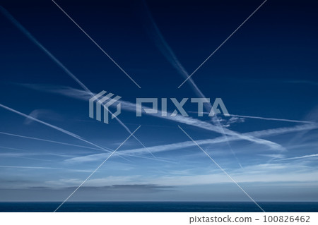 Blue Sky With Grid Of White Condensation Trails, Contrails, From Airplane At The Atlantic Coast In France 100826462