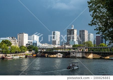 River Seine In Paris, France With Promenade, Anchored Houseboats And Modern Office Buildings 100826881