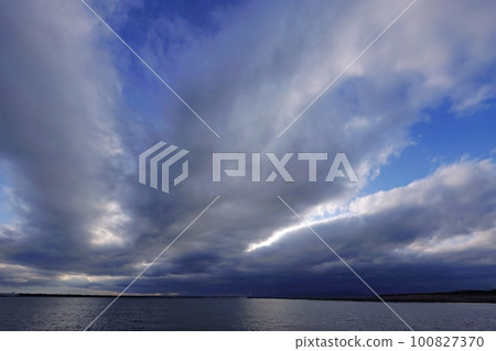 Harbor in the evening with blue sky appearing between belt-like clouds・Spring・Super wide angle・Sky mainly・230318pm 100827370