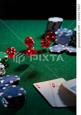 dice chips on green cloth for poker 100827607