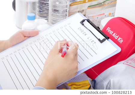 A woman checking disaster prevention goods A woman checking disaster prevention goods 100828213