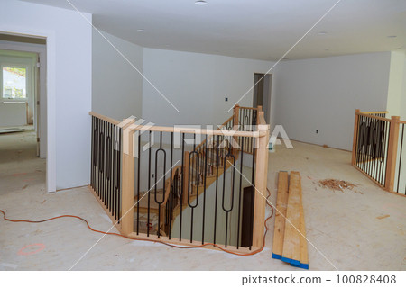 Large amount of progress is being made on assembly and installation of wooden railings in new house. Large amount of progress is being made on assembly and installation of wooden railings in new house. 100828408