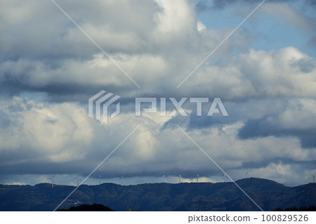 Cloudy afternoon sky and multiple wind turbines lined up on mountain ridge Spring Telephoto 230318pm Cloudy afternoon sky and multiple wind turbines lined up on mountain ridge Spring Telephoto 230318pm 100829526