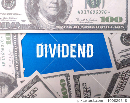 Banknotes with the word DIVIDEND on a blue background Banknotes with the word DIVIDEND on a blue background 100829848