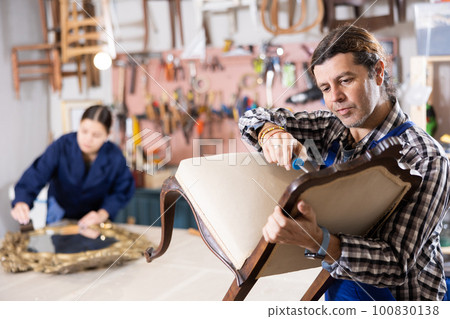 Male furniture workshop worker designing vintage chair Male furniture workshop worker designing vintage chair 100830138