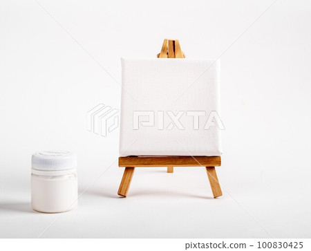 Canvas mock up on wood mini toy easel, white blank jar of gouache paint. Minimali creative tools, drawing supplies. High quality photo Canvas mock up on wood mini toy easel, white blank jar of gouache paint. Minimali creative tools, drawing supplies. High quality photo 100830425