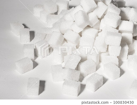 Refined sugar cubes pieces in pile, heap. Overconsumption of sugary products, unhealthy food, snacks concept. High quality photo Refined sugar cubes pieces in pile, heap. Overconsumption of sugary products, unhealthy food, snacks concept. High quality photo 100830430