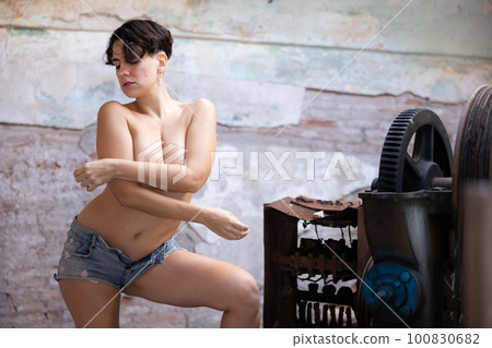 Topless photo of woman in derelict factory 100830682