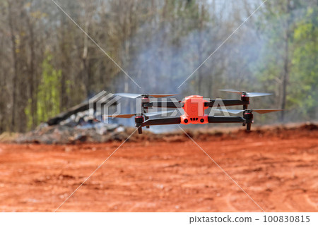 Construction site drone is being controlled by an experienced engineer architect Construction site drone is being controlled by an experienced engineer architect 100830815