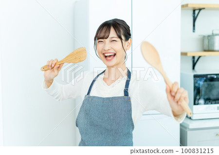 Newlywed housewife excited in the kitchen Newlywed housewife excited in the kitchen 100831215