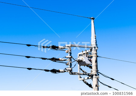 Telegraph poles and wires in the city shining in the blue sky from an angle with high saturation contrast Telegraph poles and wires in the city shining in the blue sky from an angle with high saturation contrast 100831566
