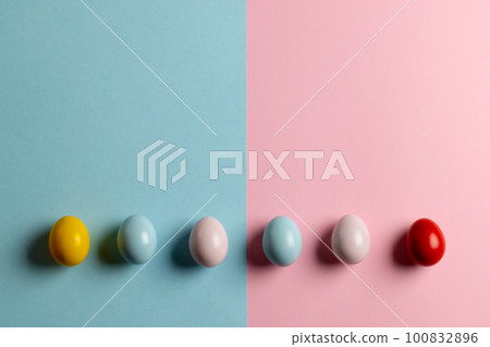 Image of multi coloured easter eggs with copy space on pink and blue background Image of multi coloured easter eggs with copy space on pink and blue background 100832896