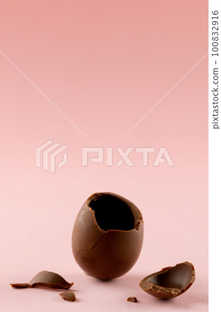 Image of broken chocolate easter egg and copy space on pink background Image of broken chocolate easter egg and copy space on pink background 100832916