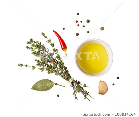Olive oil, bouquet of thyme and spices cut out 100834164
