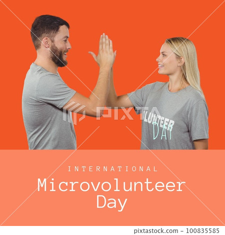 Caucasian volunteers giving high five and international microvolunteer day on orange background Caucasian volunteers giving high five and international microvolunteer day on orange background 100835585