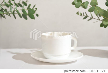 espresso coffee in a white classic cup, good morning, green leaves around a cup espresso coffee in a white classic cup, good morning, green leaves around a cup 100841171