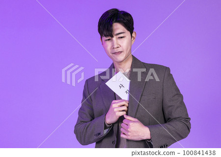 handsome Korean young man holding a letter of resignation handsome Korean young man holding a letter of resignation 100841438