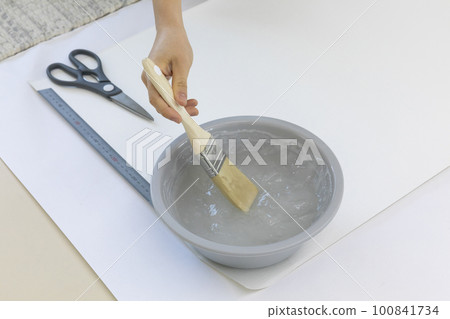 DIY interior hand motion, closeup_apply paste to wallpaper 100841734