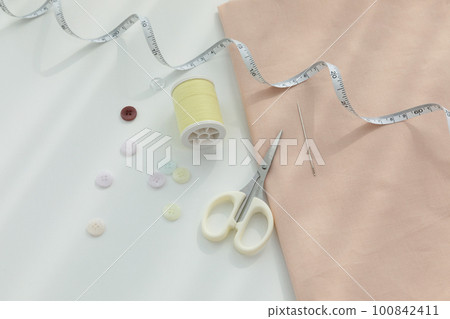 aesthetic photo of handmade, crafting hobbies, tape measure of fabric and thread buttons 100842411
