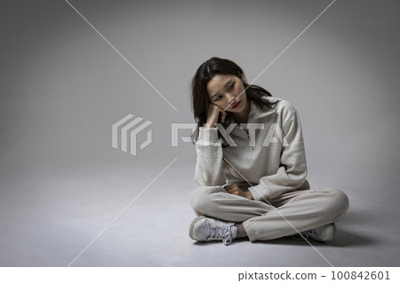 stressed, depressed Korean business woman in pink suit, worrying stressed, depressed Korean business woman in pink suit, worrying 100842601