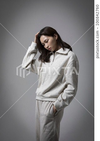 stressed, depressed Korean business woman in pink suit, worrying stressed, depressed Korean business woman in pink suit, worrying 100842760