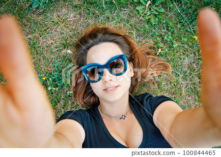 girl student lies on the grass 100844465