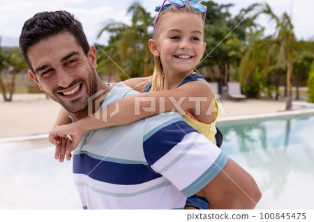 Happy biracial father and daughter embracing by the swimming pool Happy biracial father and daughter embracing by the swimming pool 100845475