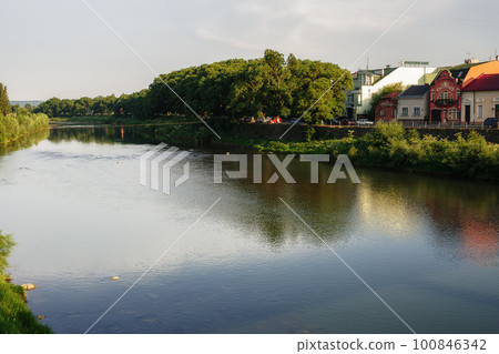 old town with river. waterfront with old architecture in the distance. beautiful urban scenery old town with river. waterfront with old architecture in the distance. beautiful urban scenery 100846342