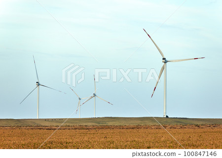 Silhouette of wind turbines at sunset. The concept of alternative energy. Silhouette of wind turbines at sunset. The concept of alternative energy. 100847146