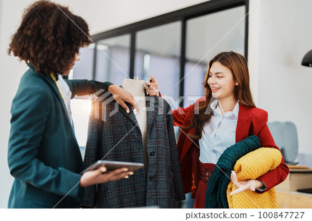 Multi ethnic young teen african american and asian woman fashion designer stylish and friend working at fashion Business studio. 100847727