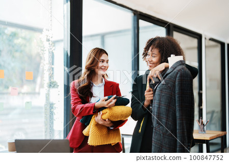 Multi ethnic young teen african american and asian woman fashion designer stylish and friend working at fashion Business studio. 100847752