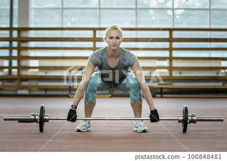 female athlete doing deadlift, exercise barbell in gym, strength training in athletics female athlete doing deadlift, exercise barbell in gym, strength training in athletics 100848481