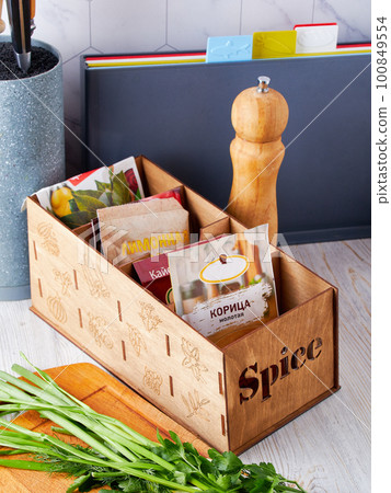 Wooden box for spices, convenient storage at home, order in the house, order in the kitchen concept Wooden box for spices, convenient storage at home, order in the house, order in the kitchen concept 100849554