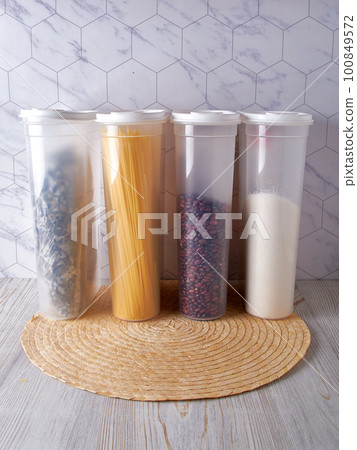 Organization of food storage in the kitchen, transparent reusable jars for cereals, coffee, sugar and pasta Organization of food storage in the kitchen, transparent reusable jars for cereals, coffee, sugar and pasta 100849572