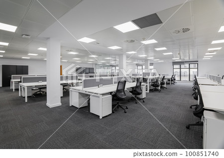 Empty gray office with tables and chairs before the start of the working day in the office center. Workplace concept with expensive furniture for skilled workers 100851740