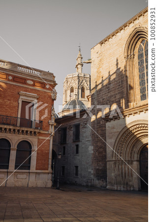 Archiepiscopal Palace of Valencia. Palace in the Old Town known as Cabildo de Valencia. Orange trees with Green leaves at facade building. Urban landscape. Ancient Architecture, Brick House. Archiepiscopal Palace of Valencia. Palace in the Old Town known as Cabildo de Valencia. Orange trees with Green leaves at facade building. Urban landscape. Ancient Architecture, Brick House. 100852931