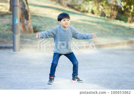 A boy kicking a soccer ball A boy kicking a soccer ball 100853862
