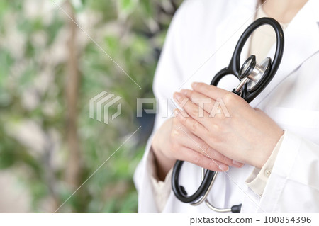 A doctor's hand holding a stethoscope Body parts A doctor's hand holding a stethoscope Body parts 100854396