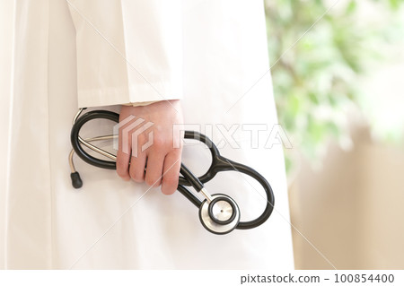 A doctor's hand holding a stethoscope Body parts A doctor's hand holding a stethoscope Body parts 100854400