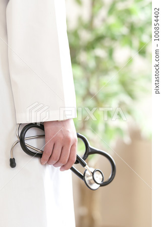 A doctor's hand holding a stethoscope Body parts A doctor's hand holding a stethoscope Body parts 100854402