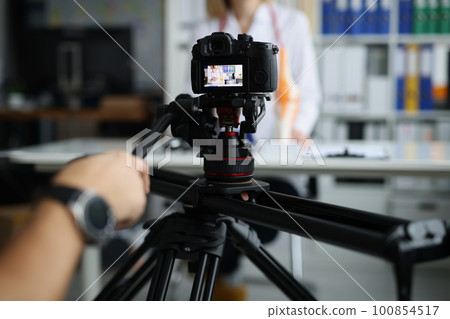 Videographer filming online broadcast about medicine in clinic with doctor 100854517