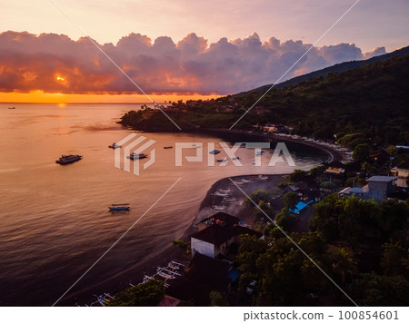 Aerial view of sunset or sunrise and quiet ocean with boats in Amed, Bali. Aerial view of sunset or sunrise and quiet ocean with boats in Amed, Bali. 100854601