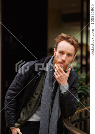 Thoughtful man posing outdoors leaning against the railing Thoughtful man posing outdoors leaning against the railing 100855909