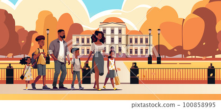 parents and little children walking together in urban park mother father and kids standing together parenthood big family 100858995