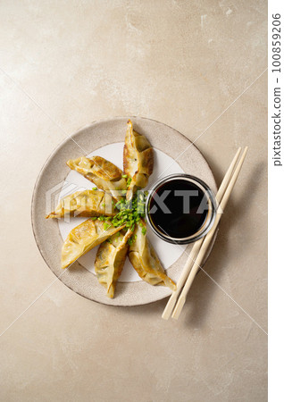 Fried dumplings gyoza with soy sauce, and chopsticks. Fried dumplings gyoza with soy sauce, and chopsticks. 100859206