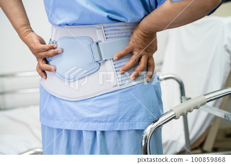 Asian lady patient use walker in hospital to support walking. 100859868